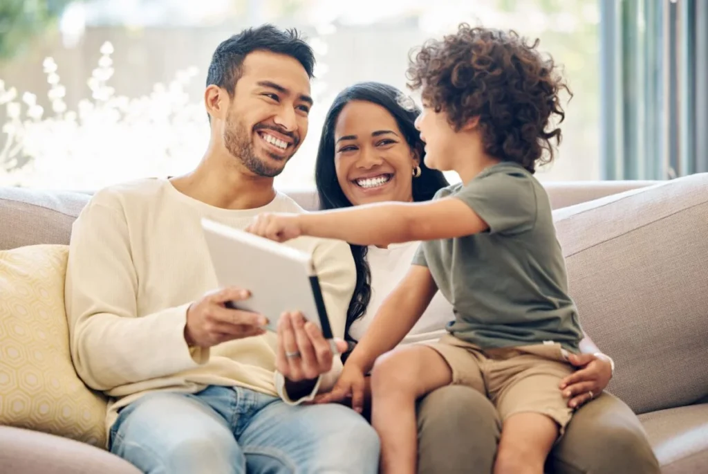 Family smiling with tablet