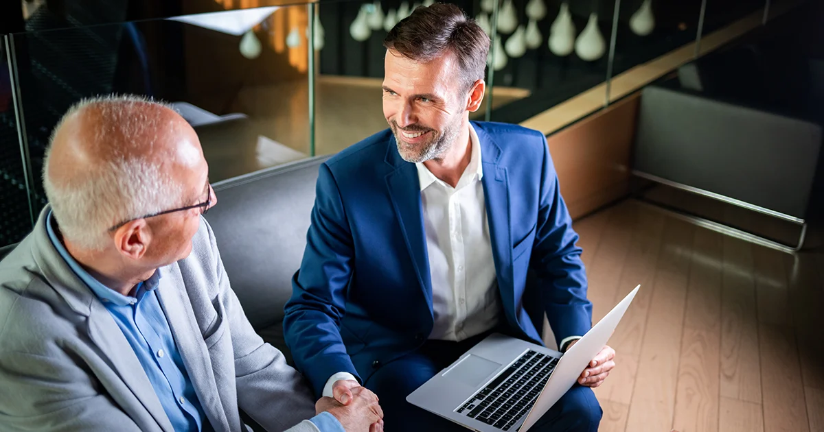 Professional wealth advisor consulting with high-net-worth client in modern office – representing personalized investment services for $250k+ portfolios in Ontario, Canada