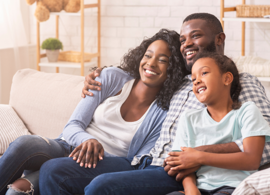 Happy Ontario family at home, representing secure loved ones' future with universal life insurance in Canada